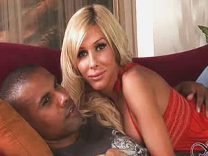 Blonde shemale model Kimber James sits on ebony penis